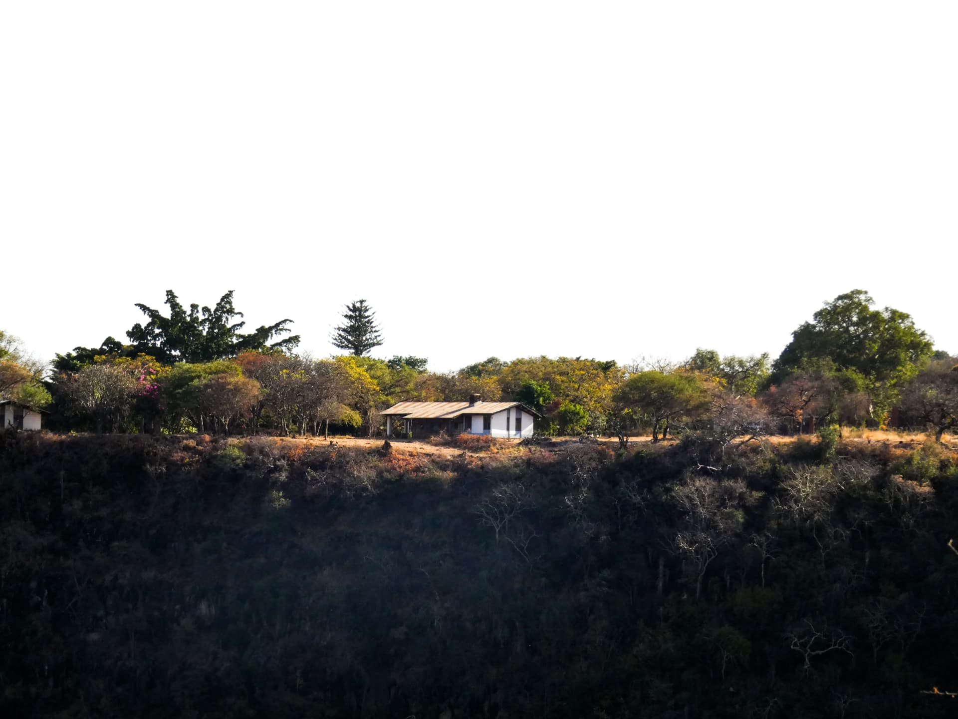 Lone house on the Rift Valley escarpment at sunset above Lake Manyara